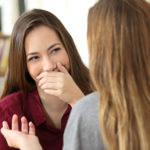 woman hiding her smile