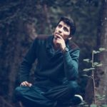 man sits wondering