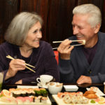 older couple eating sushi