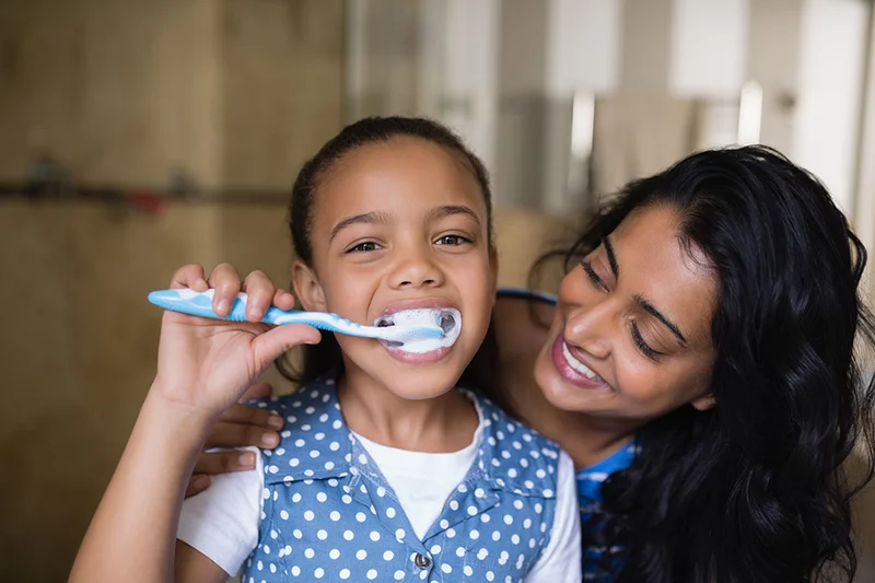 Girl brushing her teeth