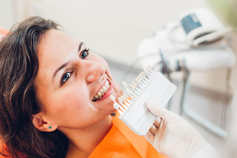 woman color matching for tooth bonding